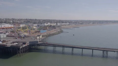 Drone or aerial pull back reveal with pan of Southend pier and sea showing the Stock-Footage 129521564