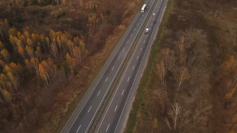 Drone or aerial view on track, driving cars and autumn trees. 4K resolution Video stock 164868420
