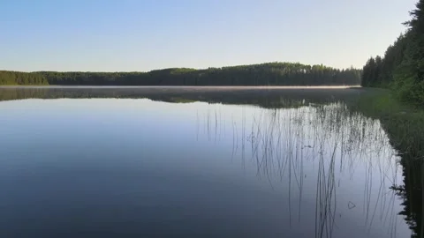 Drone or boat moving slowly forward just above the water’s calm surface  Stock Footage 244538943