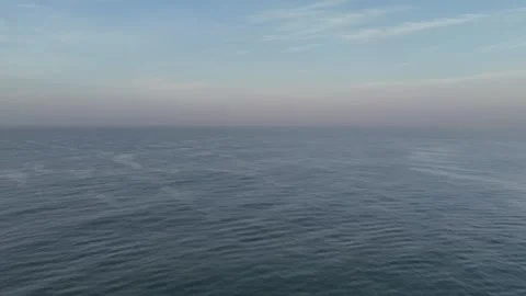 Drone Orbit Above Calm Pacific Ocean Waves at Sunrise Video stock 337914868