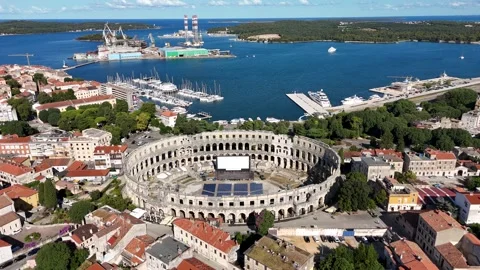 Drone orbit of ancient Croatian amphitheater in bright sunlight Stock Footage 323504196