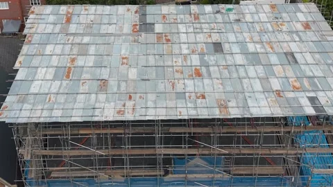 Drone orbit of apartment block renovation with scaffolding, blue netting and Stock Footage 339411593
