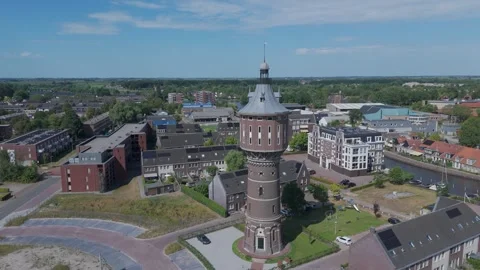 Drone orbit around historic water tower in Dutch town Stock Footage 343839466