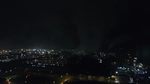 Drone orbit around illuminated blast furnace at night Stock Footage 331885486