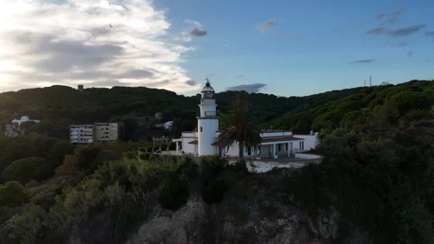 Drone Orbit Around Lighthouse With City and Mountains, Costa Brava Stock Footage 319861150