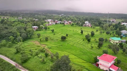 Drone orbit around lush stepped paddy fields, rural village huts, and mount.. Stock-Footage 345277321