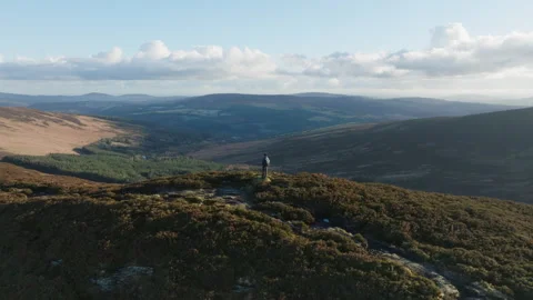 Drone Orbit Around Man Standing on Hill – Dublin Mountains, Ireland Stock Footage 312632583