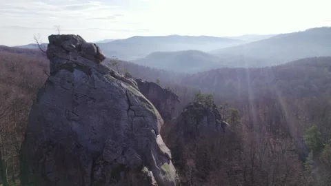 Drone Orbit Around Massive Rock Formation Rising Above Forest Stock Footage 327206464