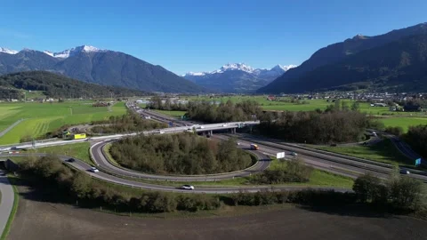 Drone orbit around motorway surrounded by big mountains in Switzerland Video stock 163768254