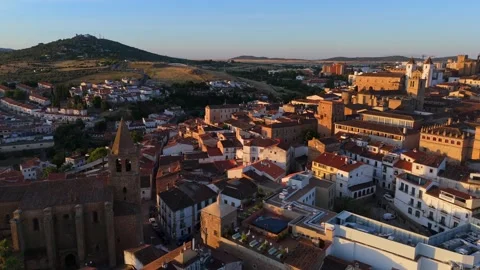 Drone orbit around old stone church above red tiled roofs of Caceres Spain Stock-Footage 342321130