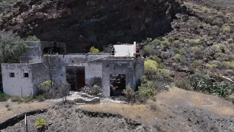 Drone Orbit Around Rugged House Ruin on Arid Hillside Stock Footage 310064604