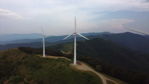 Drone orbit around single wind turbine on ridge Stock Footage 322802712