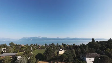 Drone Orbit Around Small Countryside Chapel, Lake and Mountains Beyond Stock Footage 341358515