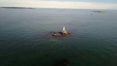 Drone orbit around small lighthouse in open water Stock Footage 72661326