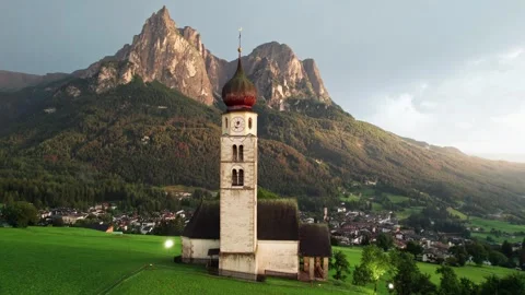Drone orbit around St Valentin church after a storm, South Tyrol Stock Footage 346288701