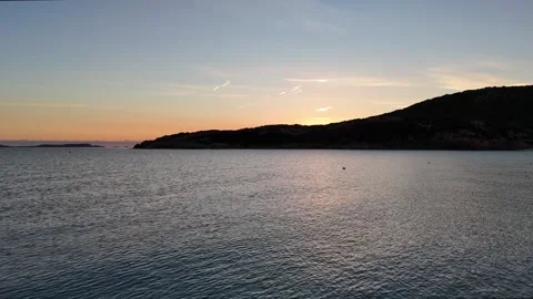 Drone Orbit Around Sunrise Beach with Turquoise Waters Stock Footage 334705654