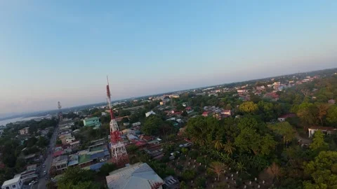 Drone Orbit Around Telecom Tower Above Coastal City at Sunset Stock Footage 333200017