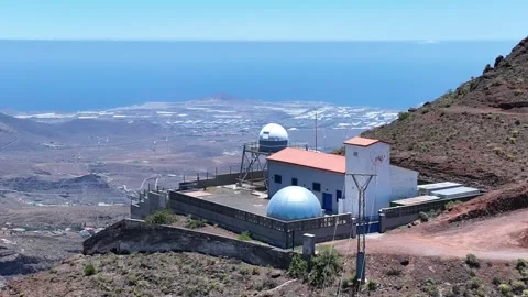 Drone orbit around Temisas Astronomical Observatory with island coastline Stock Footage 310683068