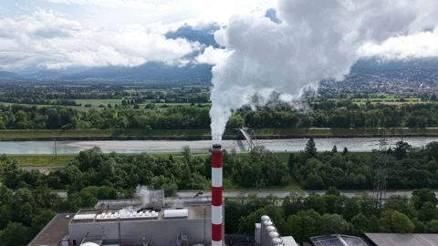 Drone orbit around waste to energy plant chimney releasing steam Video stock 335038432