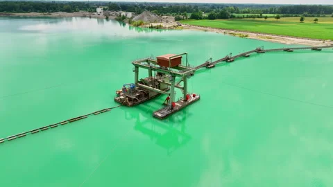 Drone orbit around water construction in turquoise lake 動画素材 315552427