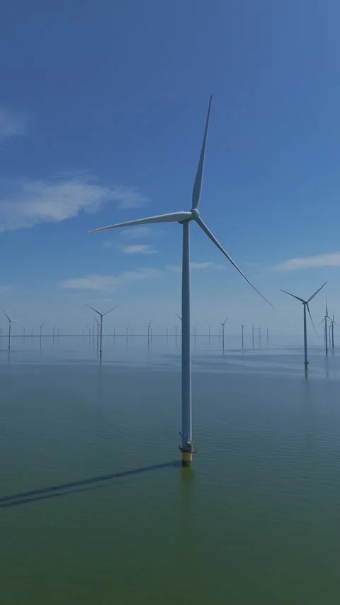 Drone orbit around wind turbine in wind farm over open water Stock Footage 345255462