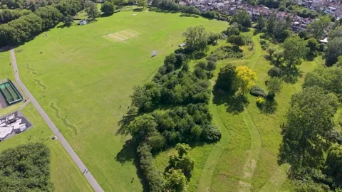 Drone orbit of crescent tree line in Chad park, Chadwell Heath, London green Stock Footage 337713777