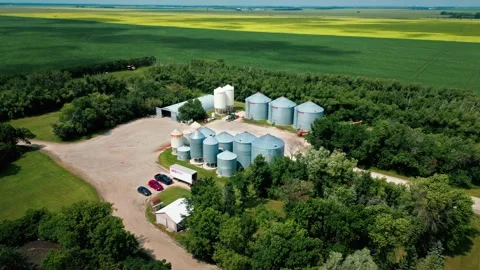 Drone Orbit of Grain and Fertilizer Bins on Prairie Farm Stock Footage 342013298