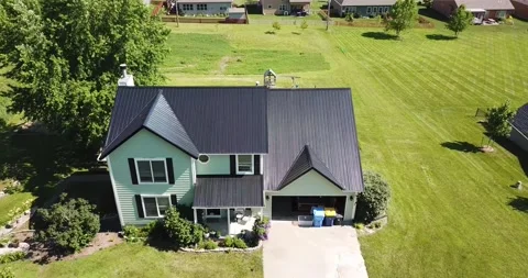 Drone Orbit of Green House with Black Metal Roof Stock Footage 201576124