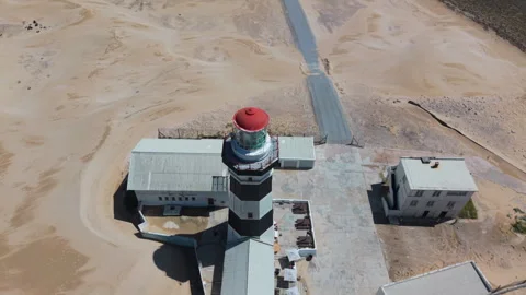 Drone Orbit of Lighthouse and Descending to Reveal Ocean, Beach, Sand, Blue Sky, Stock Footage 306262207