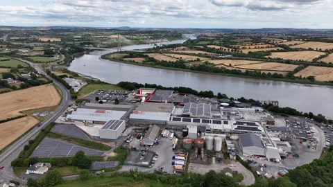 Drone orbit meat processing facility at Granagh Kilkenny Ireland with river Stock Footage 345010316