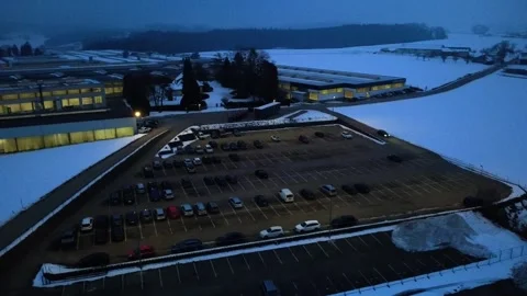 Drone Orbit Over Industrial Facility and Parking Area in Snowy Winter Morning Video stock 327478278