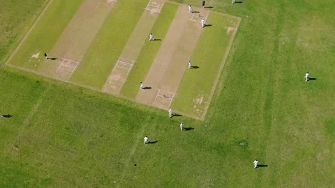 Drone orbit over men playing cricket at Chadwell Heath park, London, England Stock Footage 337724433