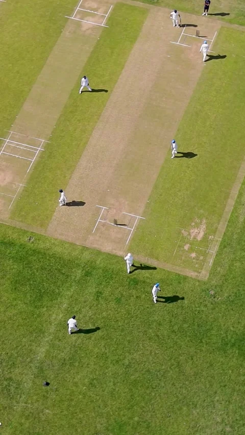 Drone orbit over men playing cricket at Chadwell Heath park, London, England Stock Footage 337799388