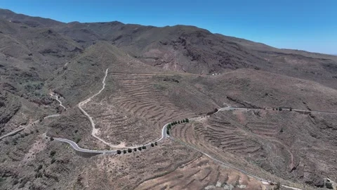 Drone orbit over mountainside terraces and ocean coastline in background Stock Footage 310683387