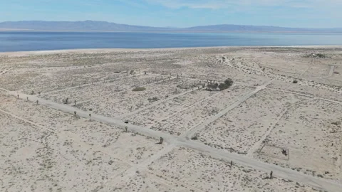 Drone Orbit Over Palm-Lined Street Grid in Salton City with Salton Sea Video stock 332683331