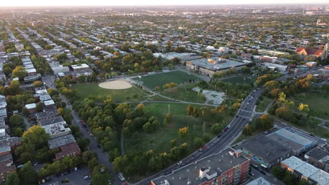 Drone orbit over Parc Père-Marquette with soccer game at sunset Stock Footage 317559058