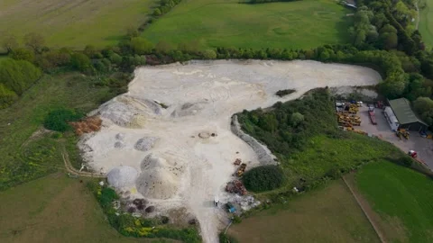 Drone orbit over sand and gravel quarry in Essendon, showing aggregate piles Vídeos de archivo 334578727