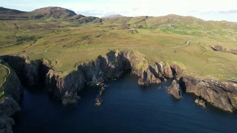 Drone orbit over a sea cliff cove at golden hour, Achill Island, Ireland Stock Footage 346745814