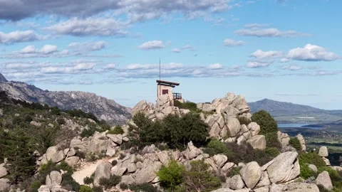Drone orbit over stone lookout hut on Navacerrada Reservoir islet Stock Footage 308018078