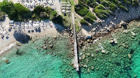 Drone Orbit Over Turquoise Waters and Sandy Beach on a Sunny Day Vídeo Stock 334127793