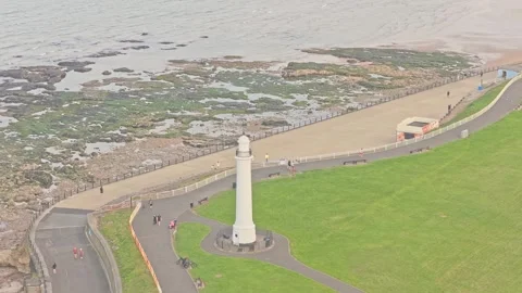 Drone orbit with parallax around Roker Lighthouse on the Sunderland coastline Vídeo Stock 340002052