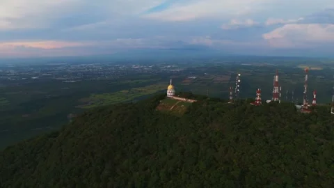 Drone Orbit Right Over La Cumbre, Colima, with Sunset and Colima City in Stock Footage 292990239