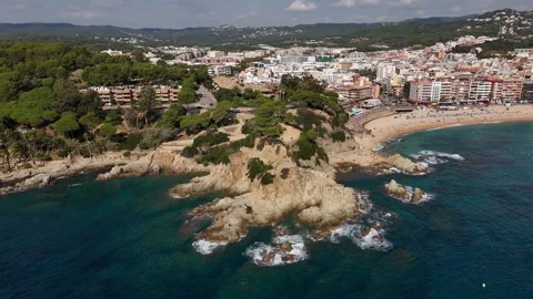 Drone orbit of scenic cape between bay and city beach Stock Footage 321345679