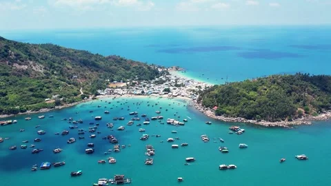 Drone orbit shot around a busy bay with boats in Hon Son island 4K Stock Footage 333939645