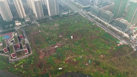 Drone orbit shot of an empty land waiting for construction to start. Outskirts Stock Footage 304215023