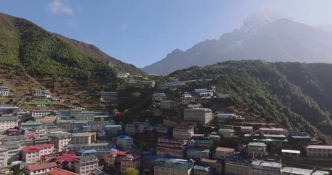 Drone orbit shot focusing closely on the colorful lodges of Namche Bazaar Stockbeeldmateriaal 337394052