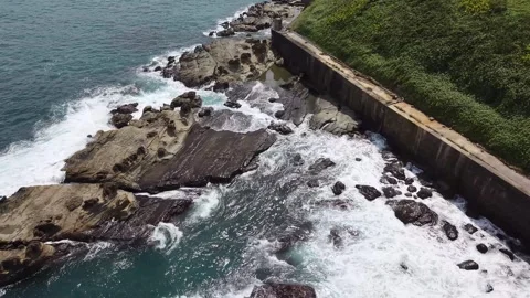 Drone Orbit Shot of Ocean Waves Crashing at Chaojing Park Keelung Taiwan Stock Footage 343940619