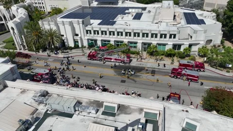 Drone orbit shot over fire engines responding emergency scene in California Stock Footage 343019519