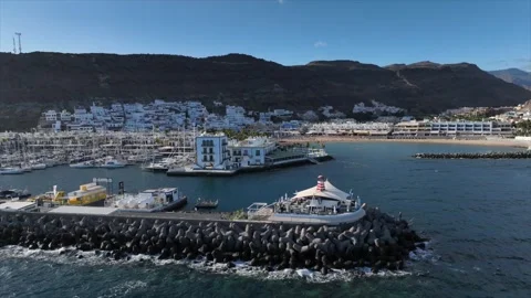 Drone Orbit Showing Puerto de Mogán and Beach Under Clear Sky – Gran Canaria Stock Footage 309951112