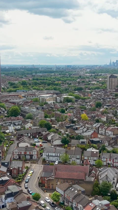 Drone orbit toward Walthamstow tower block over Selbourne Road with London Stock Footage 336848734